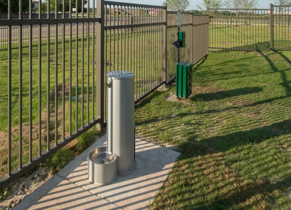 Drinking fountain for pets in the grassy, fenced-in pet park